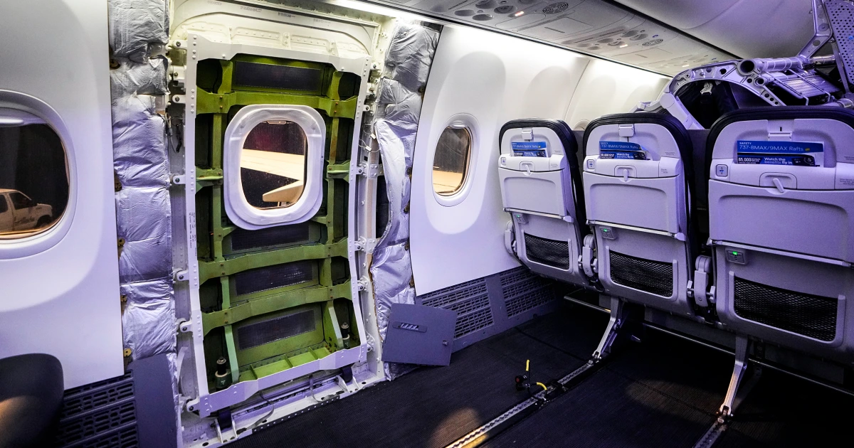 Interior of a Boeing 737 MAX showing a removed mid-cabin emergency exit door.